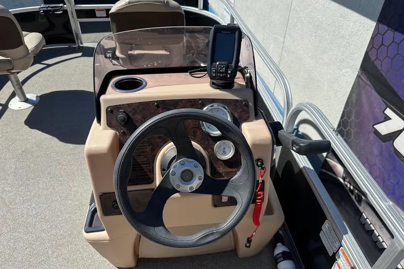 Slide: The Image of 2019 Sun Tracker Bass Buggy 18 DLX steering console with gauges and navigation device. - 21