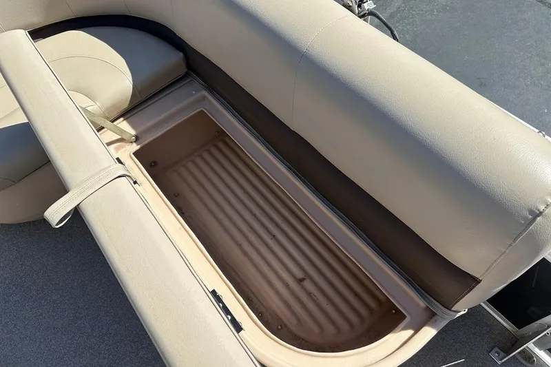 Slide: The Image of 2019 Sun Tracker Bass Buggy 18 DLX boat seat storage compartment, beige upholstery. - 26