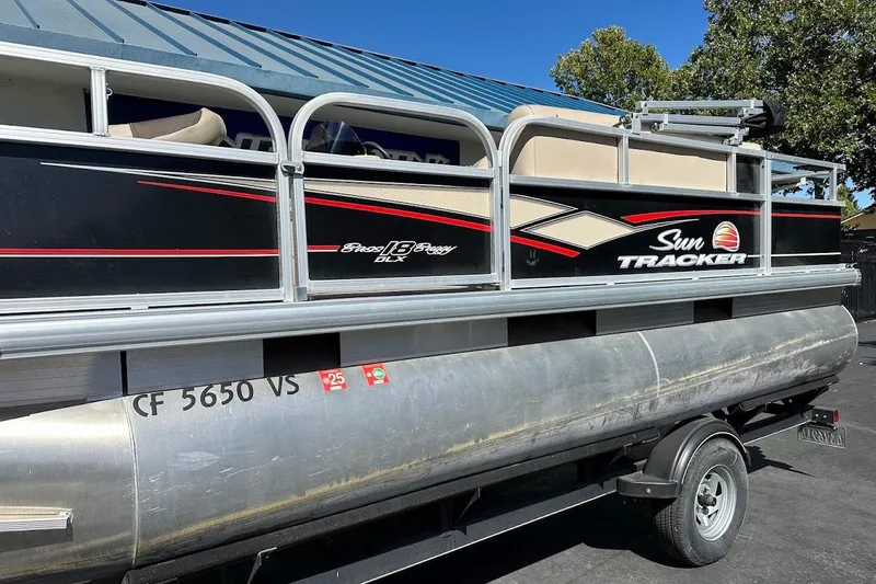 Slide: The Image of 2019 Sun Tracker Bass Buggy 18 DLX pontoon boat on trailer, side view. - 6