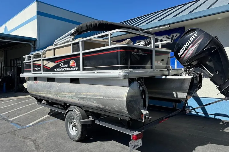Slide: The Image of 2019 Sun Tracker Bass Buggy 18 DLX pontoon boat with Mercury outboard motor on trailer. - 8