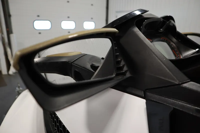 Slide: The Image of Close-up of 2013 Sea-Doo GTX 215 dashboard and mirror in a garage setting. - 12