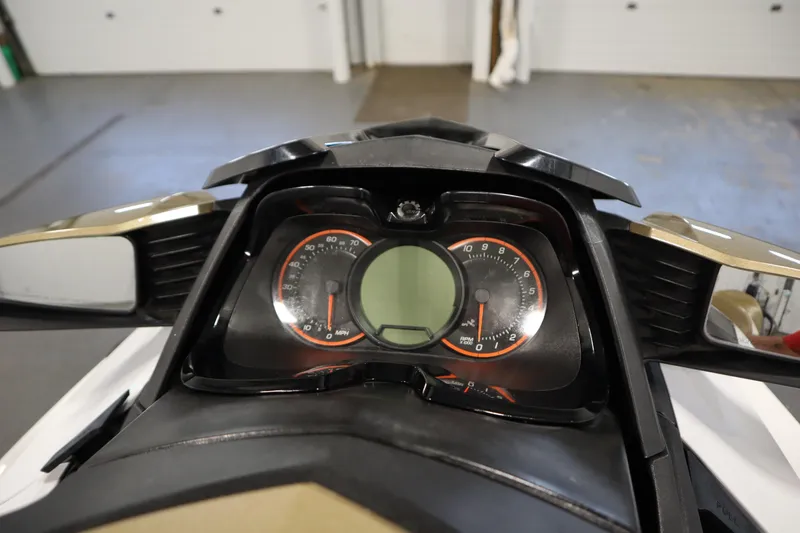 Slide: The Image of 2013 Sea-Doo GTX 215 dashboard with speedometer and tachometer in a garage setting. - 17