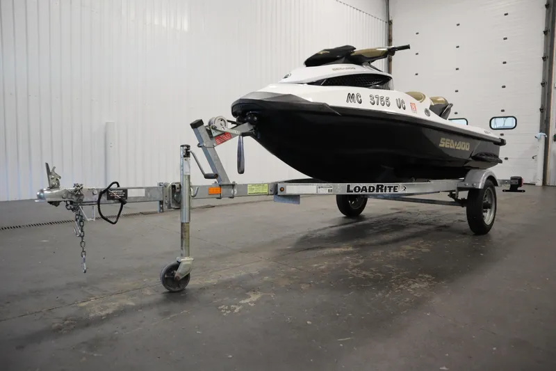 Slide: The Image of 2013 Sea-Doo GTX 215 jet ski on Load Rite trailer in a garage. - 27