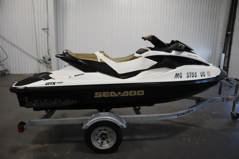 Slide: The Image of 2013 Sea-Doo GTX 215 jet ski on trailer in indoor setting. - 4