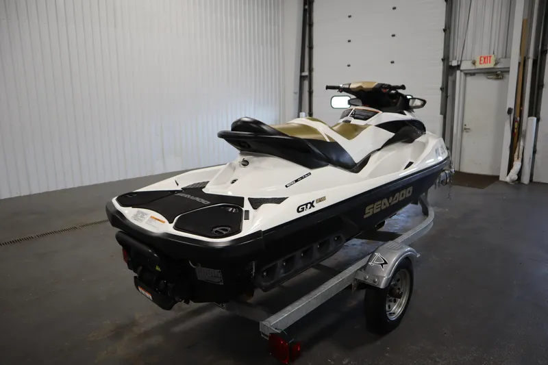Slide: The Image of 2013 Sea-Doo GTX 215 jet ski on trailer in indoor setting. - 5