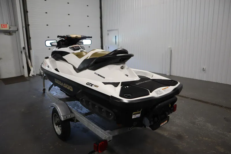 Slide: The Image of 2013 Sea-Doo GTX 215 jet ski on trailer in indoor garage setting. - 7