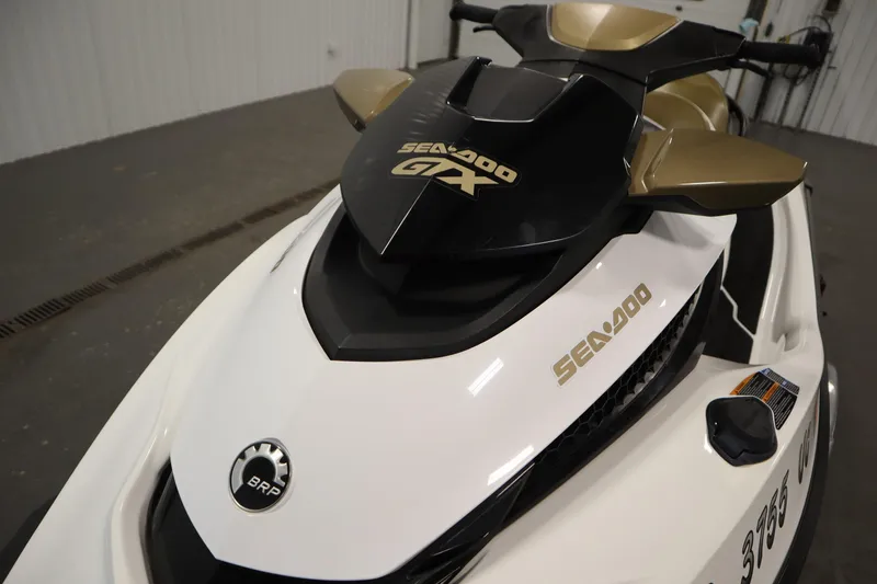 Slide: The Image of 2013 Sea-Doo GTX 215 jet ski, white and gold, in indoor setting. - 9