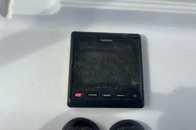 Slide: The Image of Garmin device on 2004 Jupiter 31 Center Console boat dashboard. - 10