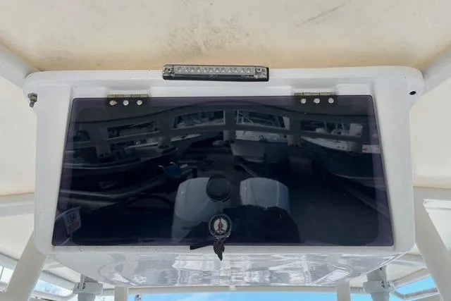 Slide: The Image of 2004 Jupiter 31 Center Console boat dashboard with protective cover and lock. - 11