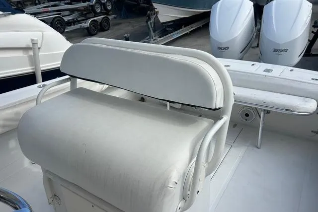 Slide: The Image of 2004 Jupiter 31 Center Console boat with white seating and dual outboard engines. - 12