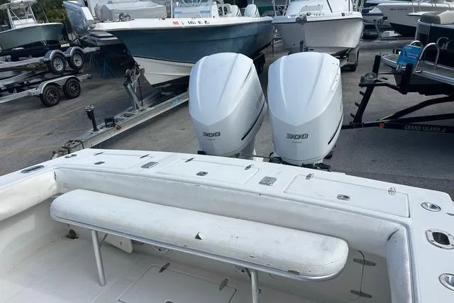 Slide: The Image of 2004 Jupiter 31 Center Console boat with twin 300 horsepower engines in a marina. - 13
