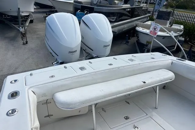 Slide: The Image of 2004 Jupiter 31 Center Console boat with twin engines, docked in a marina. - 14