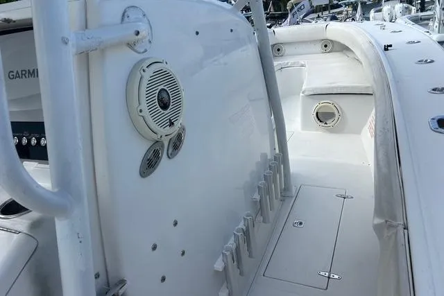 Slide: The Image of 2004 Jupiter 31 Center Console boat interior with rod holders and speaker system. - 18