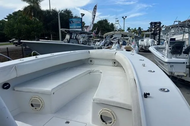 Slide: The Image of 2004 Jupiter 31 Center Console boat with spacious seating, docked among other boats. - 19