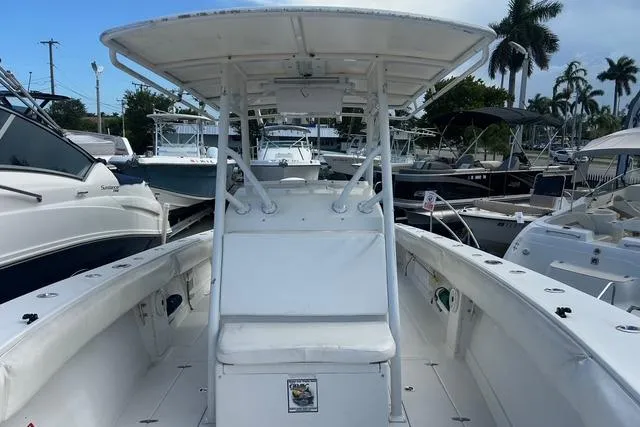 Slide: The Image of 2004 Jupiter 31 Center Console boat docked, featuring spacious seating and canopy. - 22