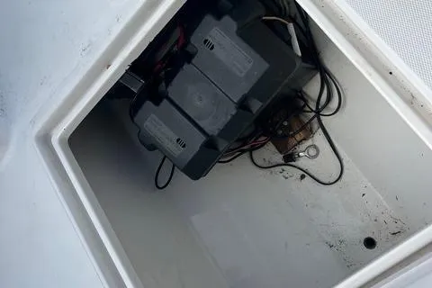 Slide: The Image of Battery compartment of a 2004 Jupiter 31 Center Console boat, showing wiring and connections. - 25
