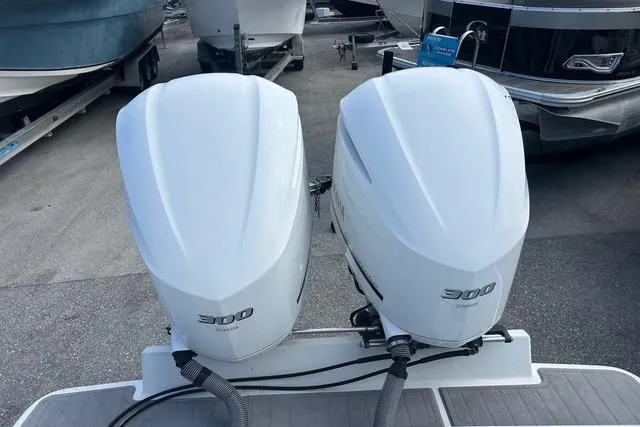 Slide: The Image of Twin 300 horsepower outboard engines on a 2004 Jupiter 31 Center Console boat. - 30