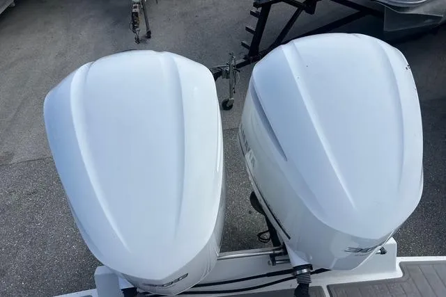 Slide: The Image of Twin outboard engines on a 2004 Jupiter 31 Center Console boat. - 33