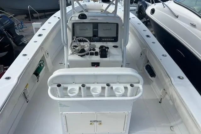 Slide: The Image of 2004 Jupiter 31 Center Console boat interior with dual Garmin displays and rod holders. - 6