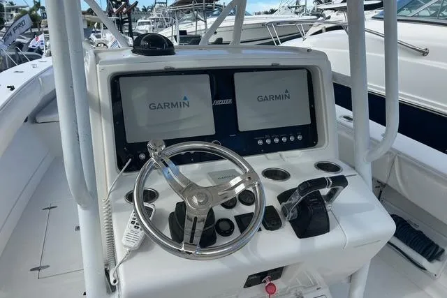 Slide: The Image of Center console of 2004 Jupiter 31 boat with Garmin navigation displays. - 7