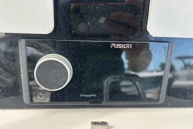 Slide: The Image of Fusion audio system on a 2004 Jupiter 31 Center Console boat dashboard. - 9