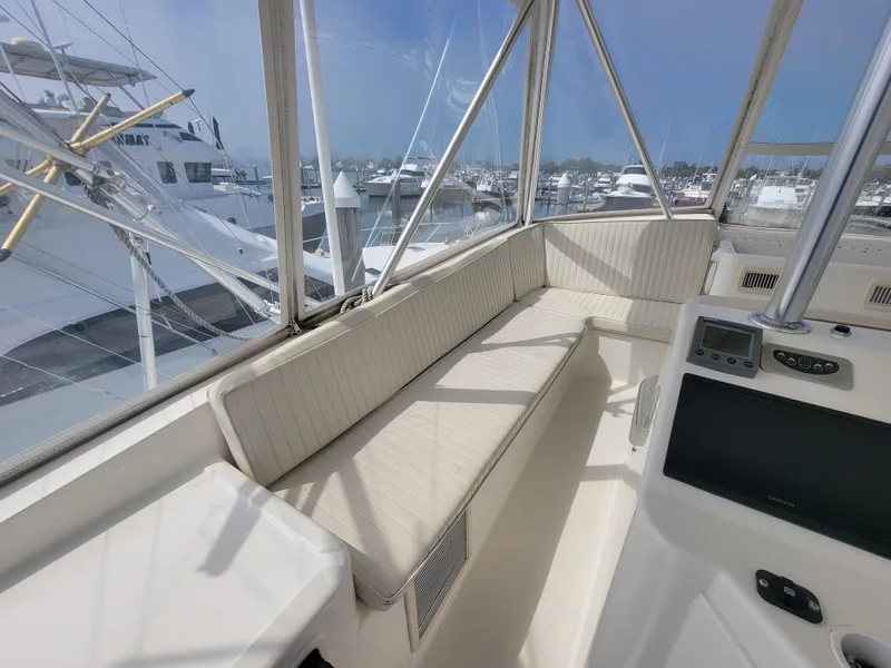 Slide: The Image of 2001 Ocean Yachts 56 Super Sport flybridge seating area with marina view. - 10
