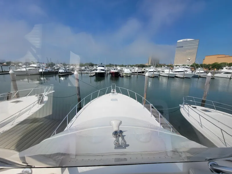 Slide: The Image of View from the bow of a 2001 Ocean Yachts 56 Super Sport in a marina. - 14