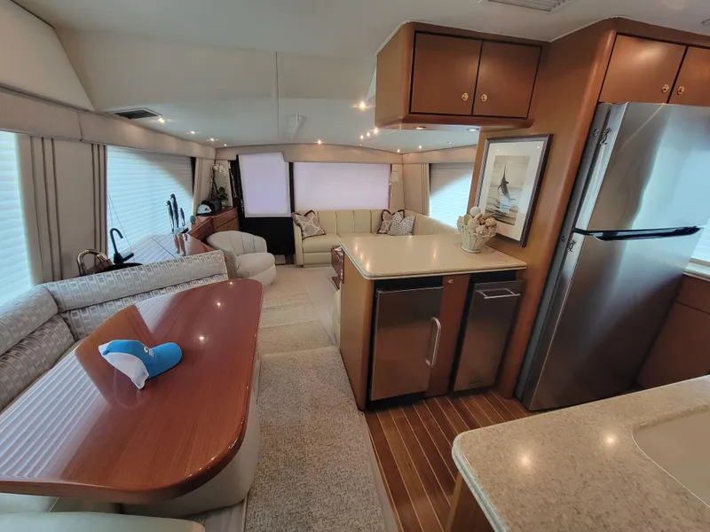 Slide: The Image of Interior of 2001 Ocean Yachts 56 Super Sport with modern kitchen and cozy seating area. - 18