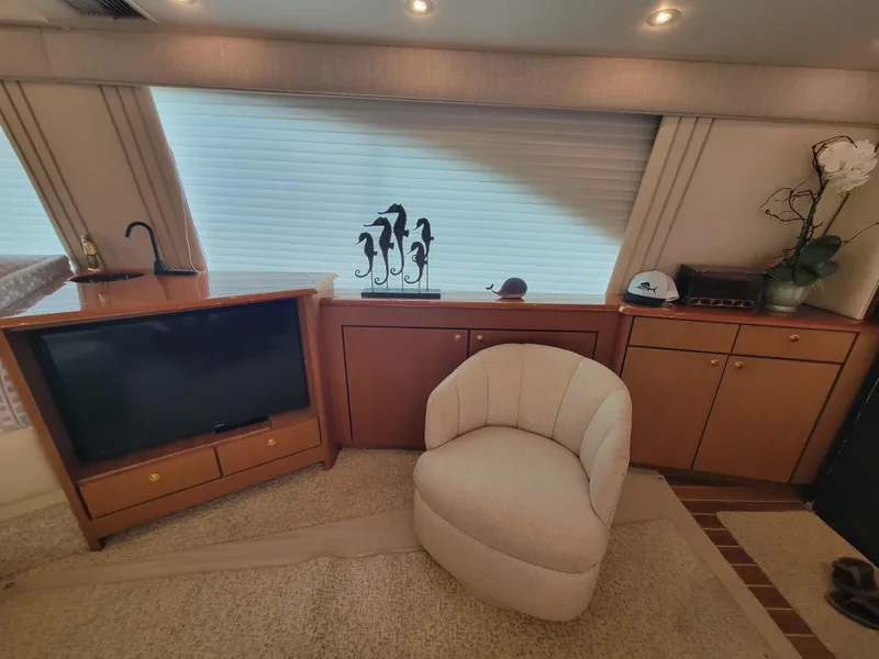 Slide: The Image of Interior of 2001 Ocean Yachts 56 Super Sport with TV, chair, and cabinets. - 19
