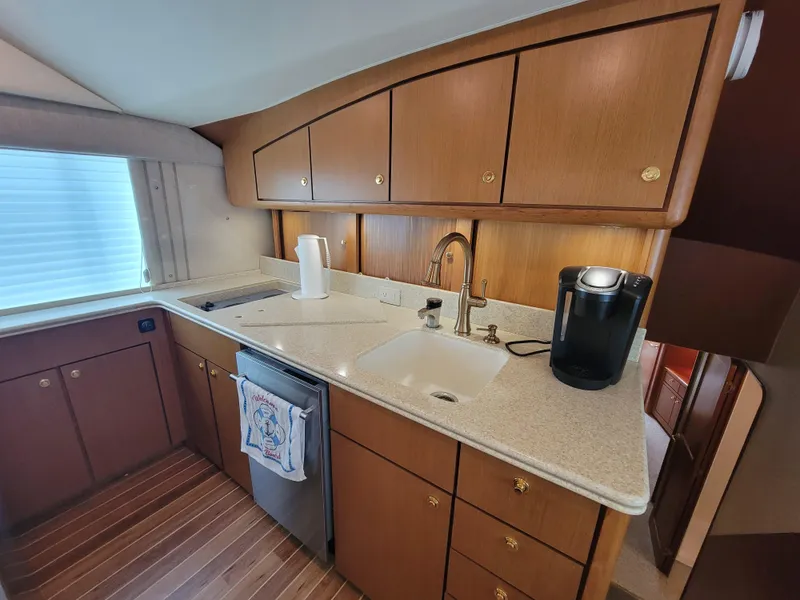 Slide: The Image of 2001 Ocean Yachts 56 Super Sport kitchen with wooden cabinets and modern appliances. - 22