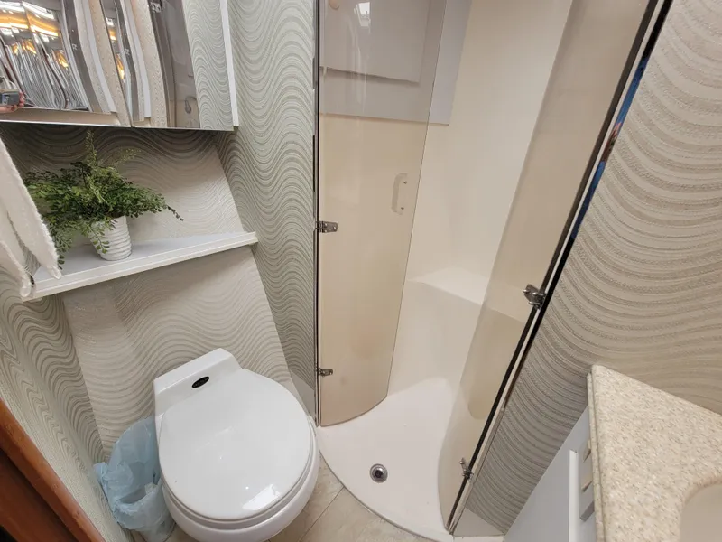 Slide: The Image of Bathroom of 2001 Ocean Yachts 56 Super Sport with shower, toilet, and vanity. - 32
