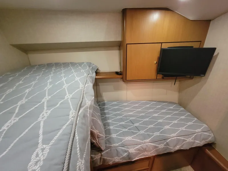 Slide: The Image of 2001 Ocean Yachts 56 Super Sport cabin with twin beds and TV. - 35