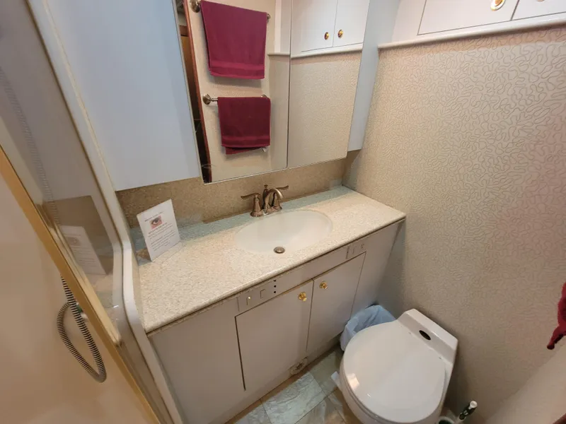 Slide: The Image of Bathroom interior of 2001 Ocean Yachts 56 Super Sport with sink, toilet, and mirror. - 36