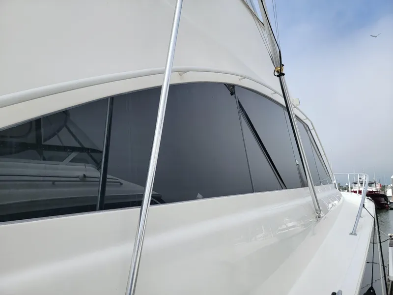 Slide: The Image of Side view of a 2001 Ocean Yachts 56 Super Sport yacht in a marina. - 42