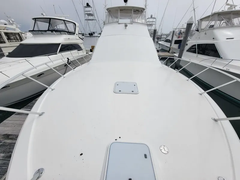 Slide: The Image of 2001 Ocean Yachts 56 Super Sport docked, view of the bow and surrounding boats. - 43