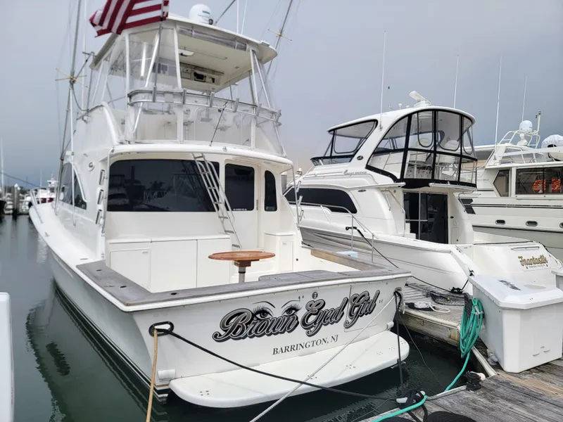 Slide: The Image of 2001 Ocean Yachts 56 Super Sport docked at a marina. - 5