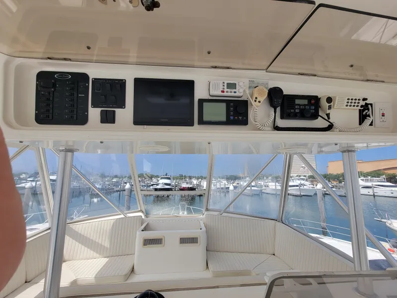 Slide: The Image of 2001 Ocean Yachts 56 Super Sport helm with navigation equipment and marina view. - 9