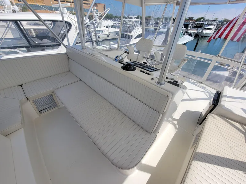Slide: The Image of 2001 Ocean Yachts 56 Super Sport yacht interior with white seating and helm station. - 12