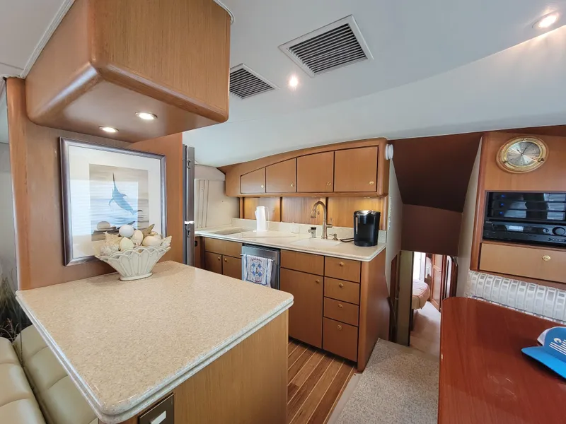 Slide: The Image of Interior of 2001 Ocean Yachts 56 Super Sport with modern kitchen and wooden cabinetry. - 21