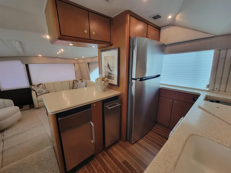 Slide: The Image of Interior of 2001 Ocean Yachts 56 Super Sport with modern kitchen and cozy living area. - 23