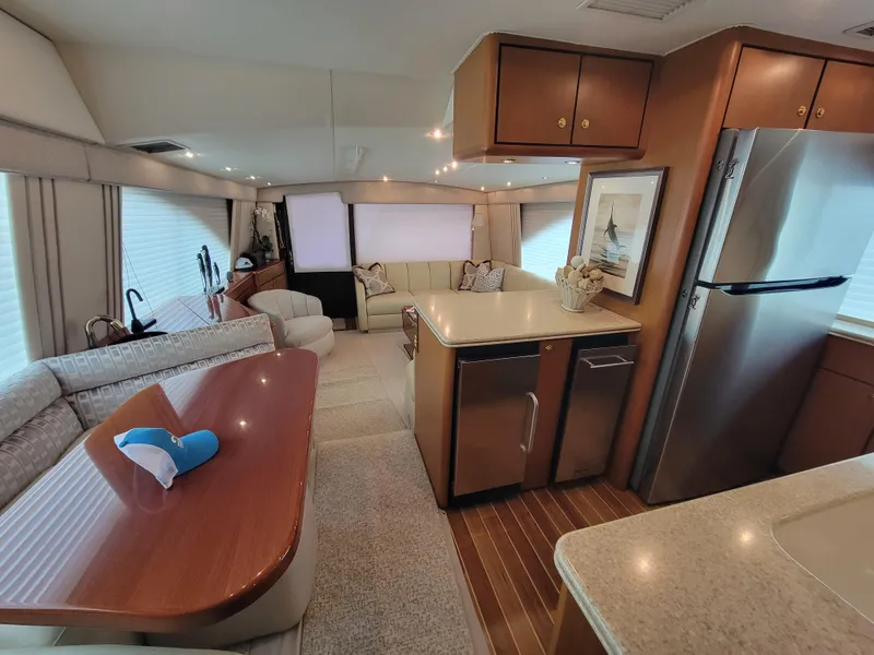 Slide: The Image of Interior of 2001 Ocean Yachts 56 Super Sport with modern kitchen and cozy seating area. - 24