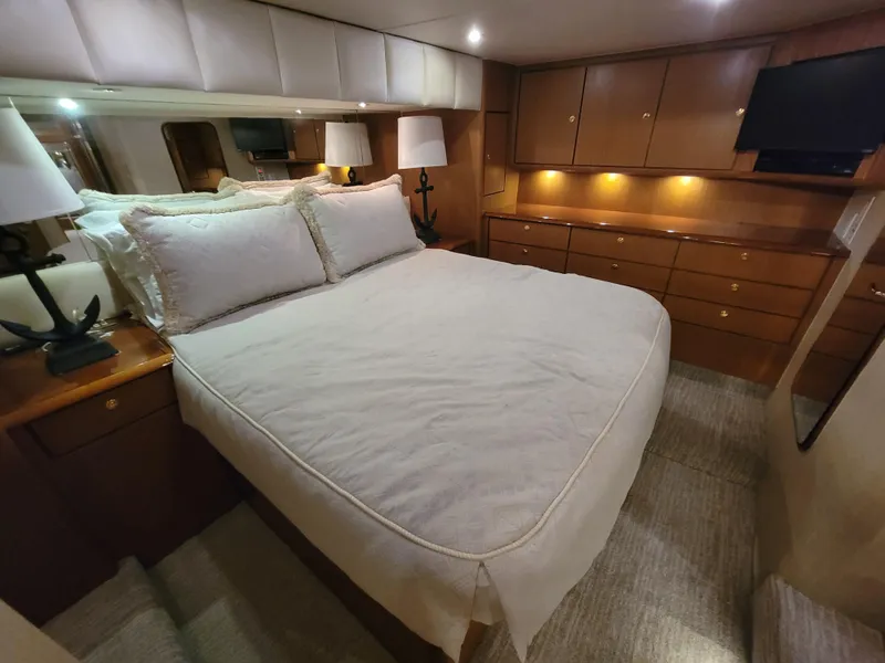 Slide: The Image of Luxurious bedroom in 2001 Ocean Yachts 56 Super Sport with ample storage and cozy lighting. - 25