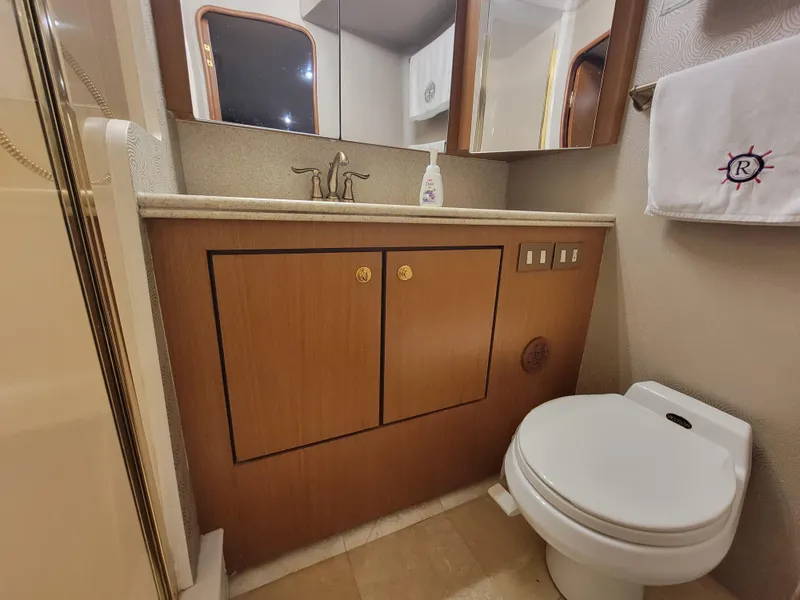 Slide: The Image of Bathroom of a 2001 Ocean Yachts 56 Super Sport with wooden cabinets and modern fixtures. - 28