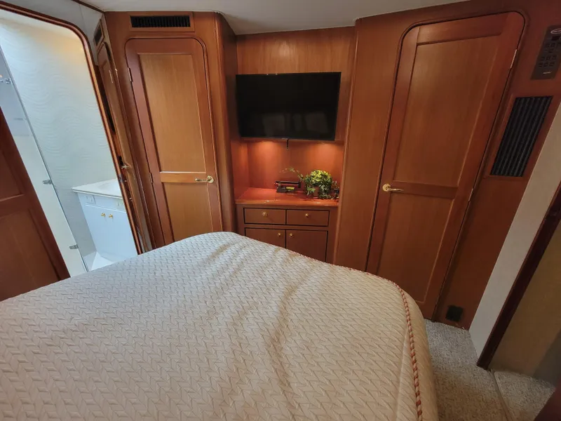 Slide: The Image of Bedroom interior of 2001 Ocean Yachts 56 Super Sport with TV and wooden cabinetry. - 30