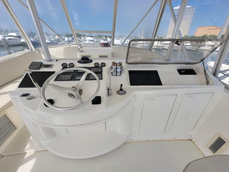 Slide: The Image of Helm station of a 2001 Ocean Yachts 56 Super Sport with marina view. - 7