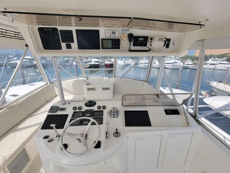 Slide: The Image of 2001 Ocean Yachts 56 Super Sport helm station with marina view. - 8