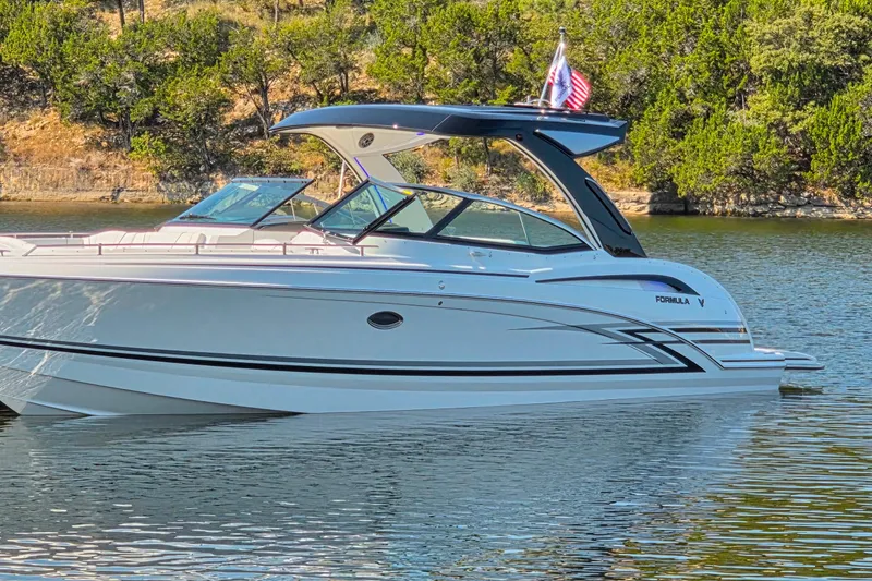 Slide: The Image of Interior of 2026 Formula 350 Crossover Bowrider I/O with sleek seating and modern speaker system. - 16