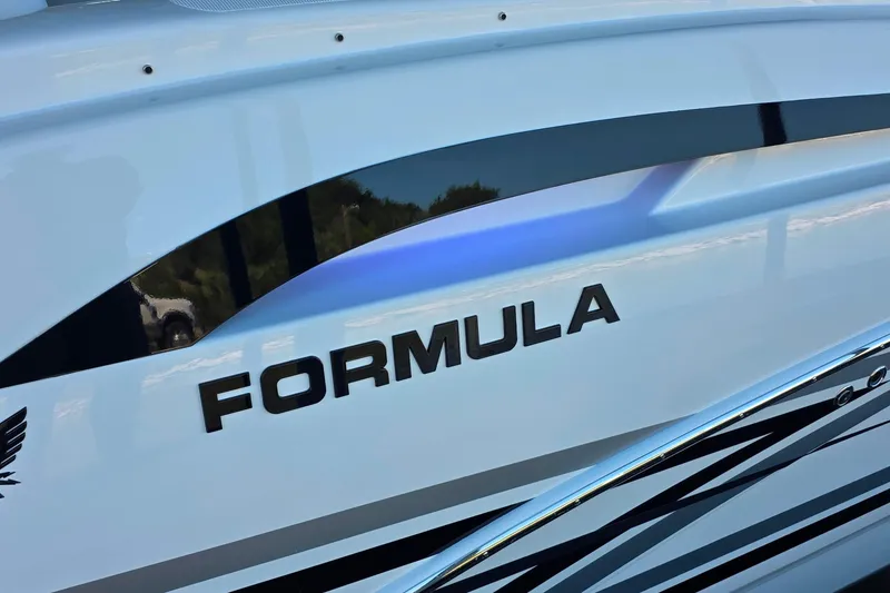 Slide: The Image of 2026 Formula 350 Crossover Bowrider I/O with spacious seating at a marina. - 17