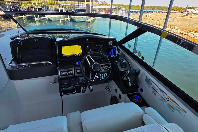 Slide: The Image of 2026 Formula 350 Crossover Bowrider I/O bathroom with modern sink, toilet, and porthole window. - 27