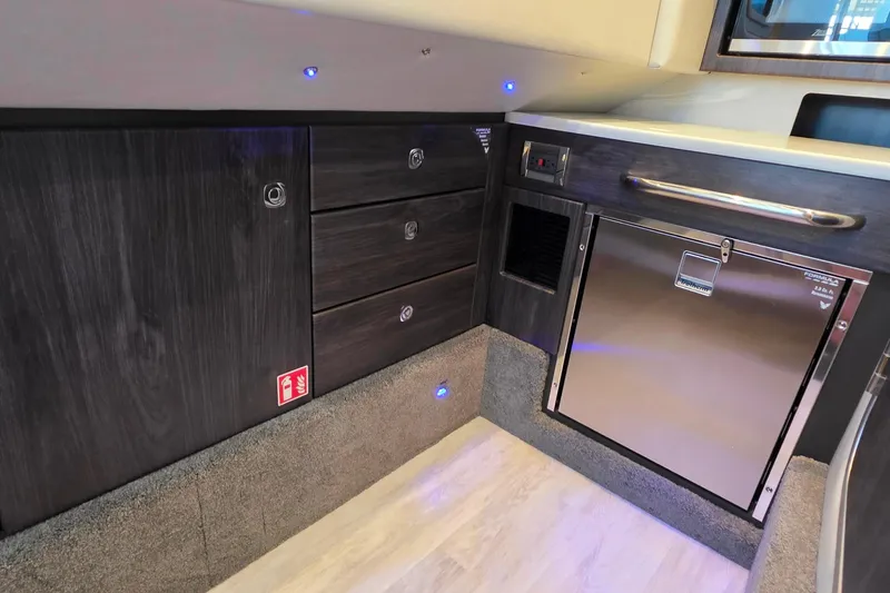Slide: The Image of Manufacturer Provided Image: Interior of 2026 Formula 350 Crossover Bowrider I/O with open storage drawers and cabinet. - 43